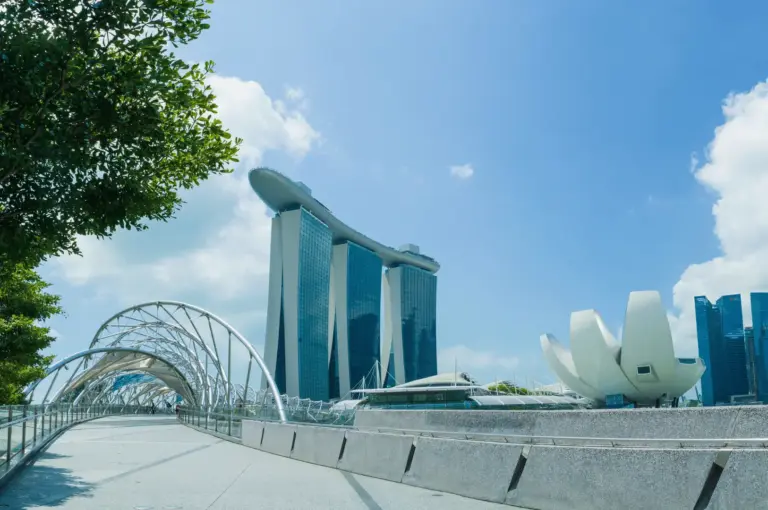 The bustling Singapore skyline and Central Business District at dusk, highlighting the vibrant urban center where high-end dining meets historic riverside eateries.