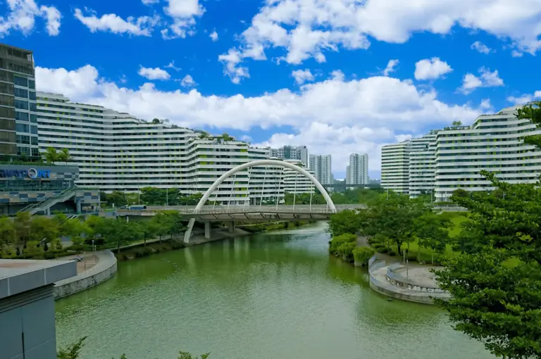 A modern waterfront view of Punggol’s residential skyline, featuring sleek HDB designs and green corridors that lead to the district's popular riverside dining clusters.