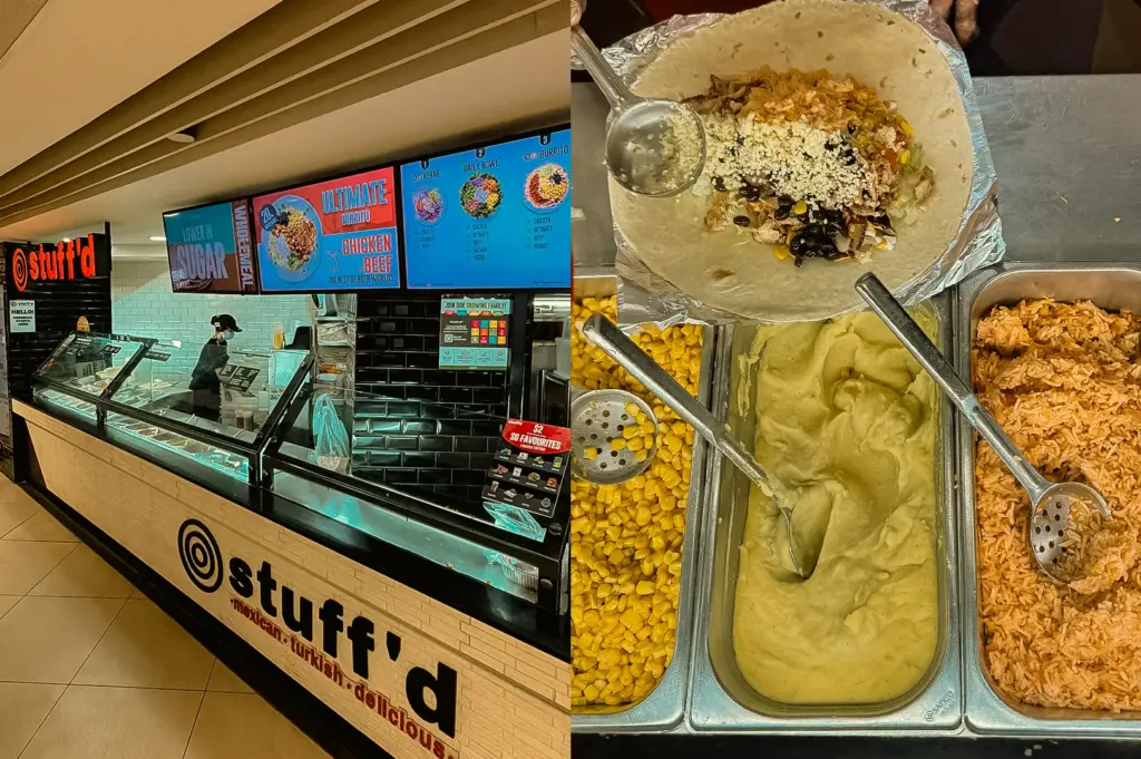 Left: A three-quarter, wide-angle shot of a fast-casual food counter branded with large text, featuring overhead digital menu screens displaying burrito and daily bowl options, a glass sneeze guard protecting food assembly trays, and a masked staff member working in the background. Right: A top-down, close-up shot of an open flour tortilla wrapper filled with black beans, corn, white cheese crumbles, and rice, placed above three stainless steel food pans containing yellow corn kernels, mashed avocado, and seasoned orange rice with serving spoons.