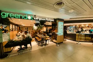 Wide-angle eye-level shot of Greendot Junction 8 restaurant in Bishan, showcasing clean modern interior and plant-based dining space in Singapore