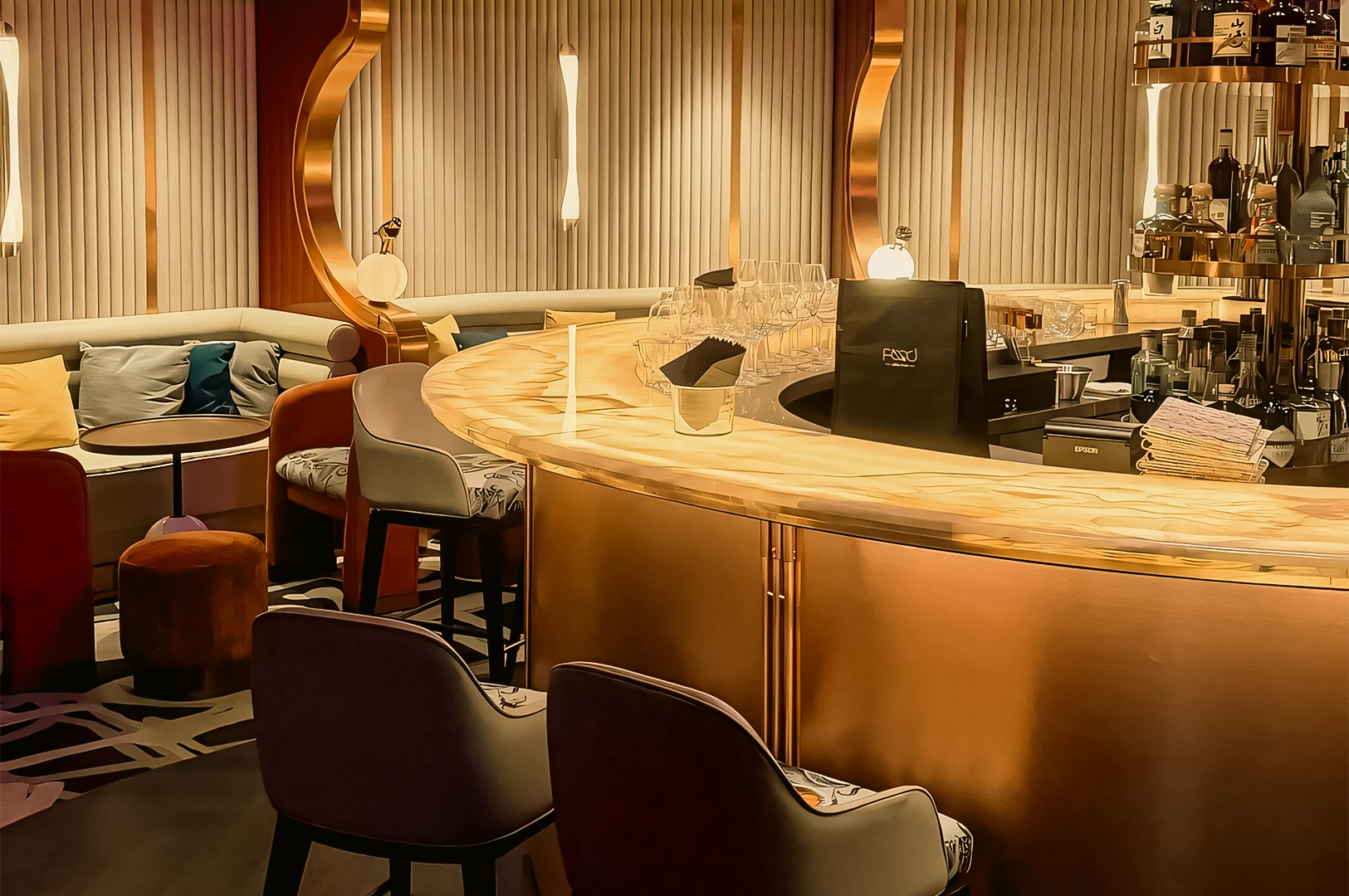 Eye-level wide-angle shot of The Whisper Room Singapore featuring a curved marble cocktail bar, Art Deco gold accents, plush lounge seating, and warm ambient lighting in an elegant nightlife setting