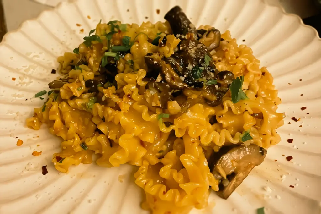 Close-up overhead shot of truffle mushroom handmade pasta at Clovelly Serangoon with creamy sauce, wild mushrooms, and ruffled pasta in a modern Singapore cafe