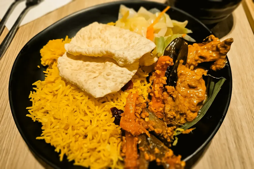 Close-up top-down shot of vegan rendang with rice at Greendot Junction 8, featuring soy protein, vegetables, and rich plant-based curry in Singapore