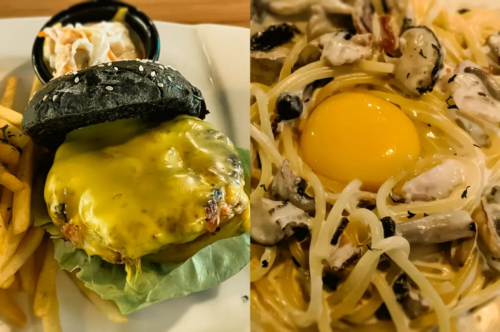 Split food image of The Larder Cafe in Toa Payoh featuring a charcoal bun cheeseburger with fries and coleslaw on the left and a creamy mushroom pasta topped with a raw egg yolk on the right, captured in a close-up top-down shot highlighting rich textures and gourmet presentation.
