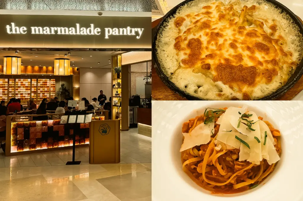 “Left: Wide-angle eye-level view of The Marmalade Pantry restaurant entrance, featuring an illuminated storefront sign, warm golden lighting, dining tables filled with guests, decorative wall displays, polished flooring, and a contemporary café interior with clean architectural lines. Upper Right: Top-down close-up of Truffle Mac and Cheese baked in a black serving dish, topped with a golden-brown melted cheese crust and visible pasta beneath the creamy surface, highlighting rich textures and caramelized edges. Lower Right: Top-down close-up of crabmeat pasta served in a white bowl, featuring long pasta strands coated in a reddish sauce, topped with shaved cheese and green herb garnish, emphasizing layered textures and vibrant presentation.”