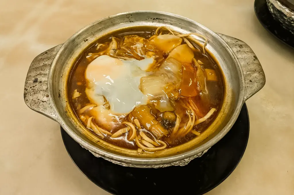Claypot e fu noodles with soft egg and mushrooms at YY Kafei Dian Singapore, close-up top angled food shot