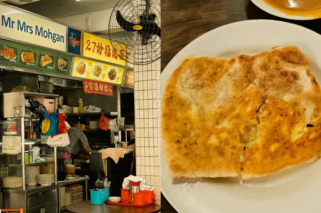 Left: Eye-level view of the Mr Mrs Mohgan food stall inside a hawker-style eatery, showing menu boards, preparation counters, stacked plates, cooking equipment, a wall-mounted fan, and open kitchen activity under bright indoor lighting. Right: Top-down close-up shot of a golden-brown roti prata on a white plate, showcasing its crisp surface, flaky layers, uneven toasted patterns, and subtle sheen from cooking oil against a dark wooden tabletop.