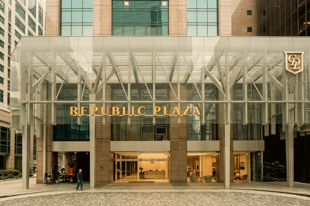 An exterior eye-level view of the Republic Plaza building entrance, featuring a modern glass canopy with bold gold lettering and steel framework extending over a cobblestone driveway.