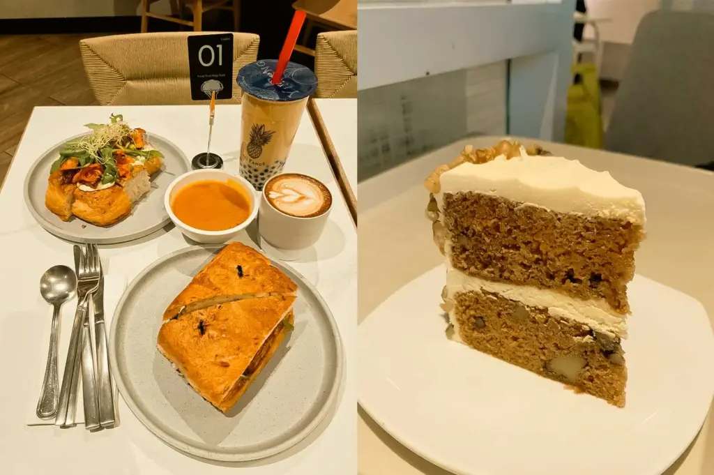 A split composition featuring a café table setup on the left with a toasted sandwich, open-faced avocado toast, a bowl of soup, a hot latte, and a bubble tea drink, next to a close-up on the right of a tall slice of two-layer carrot cake frosted with cream cheese and topped with walnuts, served on a square white plate.